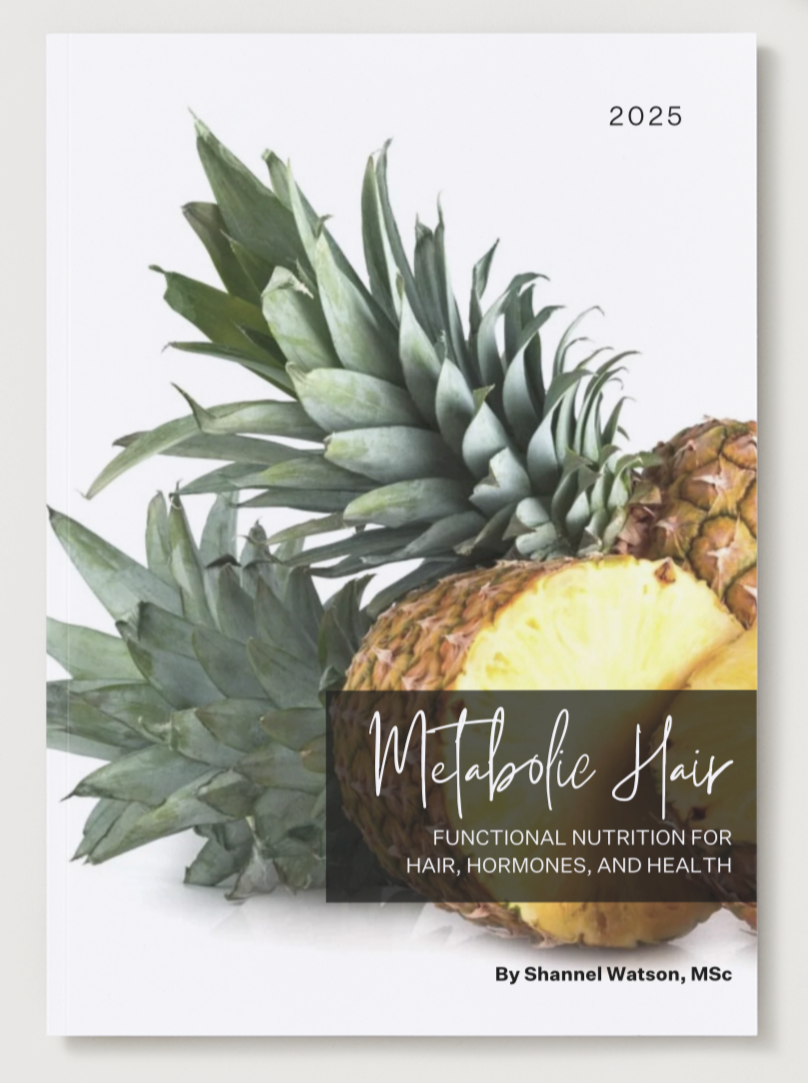 Book titled 'Metabolic Hair' with pineapples on a white surface